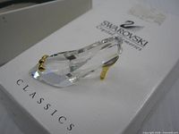 Side view of faceted crystal slipper on Swarovski Classics box