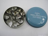 Tin closed and open with cutters inside