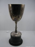 Frontal view of entire trophy showing cup, stem and base