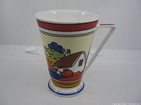 Profile view showing cottage scene and handle