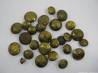 All twenty-seven Canadian Army brass buttons assorted sizes displayed