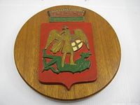 Front view of wooden plaque displaying full crest