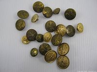 Group of 21 RCAF brass buttons varying sizes on white background