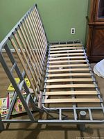 Frame with head section raised showing slats and metal structure