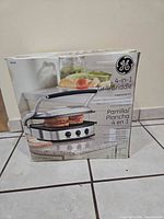 Front of box showing GE 4-in-1 Grill/Griddle image and branding