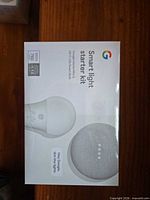 Front of sealed Smart Light Starter Kit box showing product images and branding