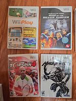 Front covers of Wii Play, Fantastic Four Rise of the Silver Surfer, TopSpin 4, MadWorld game cases