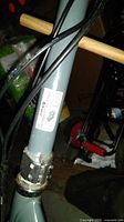 Close-up of gray frame tubing with barcode label and control cables