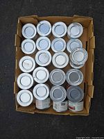 Open tray showing top view of numerous sealed fuel cans