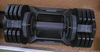 Top view of full adjustable dumbbell showing plates and handle