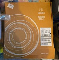 Closed Zumba branded carton showing logo and circular graphic
