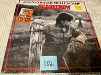Front cover of John Cougar Mellencamp Scarecrow LP with hype sticker and shrink