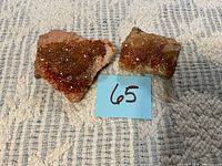 Front view of both rocks showing druzy crystal surfaces next to note 65