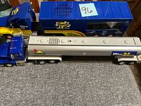 Top view of both Sunoco toy trucks: silver tanker with blue cab, blue racing hauler trailer with cab