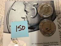 Front of United States Mint 50th Anniversary Kennedy Half-Dollar set with two encapsulated coins