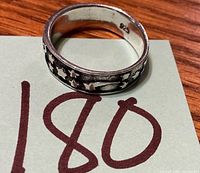 Ring angled showing interior 925 stamp and exterior star motif