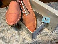Pair of coral A New Day espadrille flats resting on open box