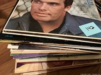 Side view of stacked LP records showing Merle Haggard cover on top