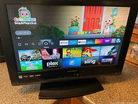 Front view of powered on Sylvania TV showing Fire TV home screen