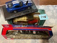 Overview of three boxed die-cast vehicles stacked
