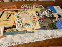 Overview of assorted ephemera and photos spread on table