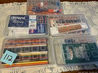 Five clear plastic pencil cases shown closed with visible contents