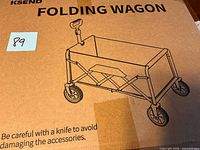 Front of sealed KSEND folding wagon box with product illustration and lot sticker