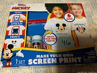 Front of boxed Mickey Make Your Own Screen Print kit showing contents window and graphics