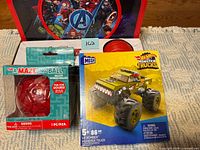 Front view of all three boxed toys: Avengers hoop set, Maze-ing Ball, Mega Hot Wheels V8 Bomber set
