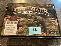 Top view of closed Dinosaur Century toy box showing graphics and 12PCS marking