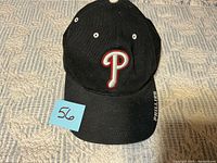 Front view of black Phillies cap showing embroidered P logo