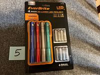 Front view of sealed EverBrite 4-pack LED penlights with batteries