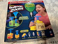 Front view of sealed Balloon Zoom box showing contents and features