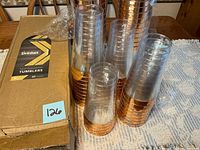 Box and stacks of Drinket rose gold tumblers