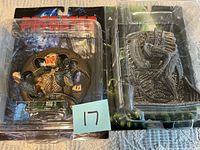Both sealed Predator and Alien wall relief figurines in packaging