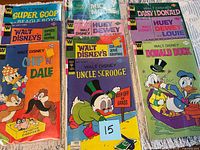 Three stacks of bagged Walt Disney comics showing multiple titles