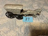 Full side view of cast iron horse and carriage with size reference