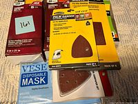 Overview of all boxed sanding supplies and mask