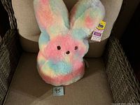 Full view of Peeps bunny plush on chair