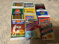 Overview of nine sealed trading-card packs on carpet
