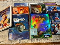 Group shot of all eight Disney DVDs on tabletop