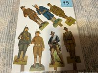 Full view of all seven paper figures on backing