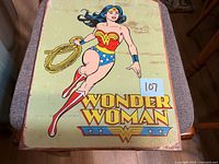 Full view of Wonder Woman tin sign on chair surface