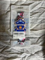 Front view of sealed plastic pouch containing floral scrunchie Apple Watch band