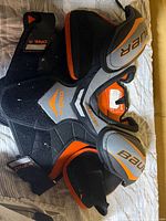 Full view of Bauer One.4 shoulder pads showing front, color scheme and straps