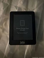 Front view of Kobo eReader displaying charge prompt