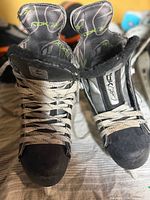 Front view of both skates showing laces, tongues with Rbk logo, and blade holders