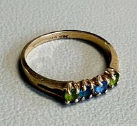 Ring angled view showing gemstone arrangement and band