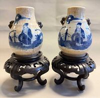 Pair of porcelain vases on stands, front view