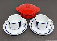 Group shot of two Rosenthal cup & saucer sets with red cocotte